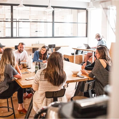 group of young people sit in a business casual office