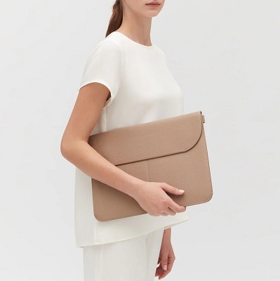 woman holds beige 