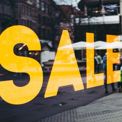 big yellow letters read SALE in shop window
