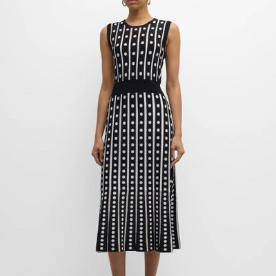 A woman wearing a black and white print sleeveless dress