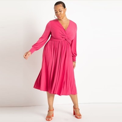 A woman wearing a pink knot-front dress and pink shoes