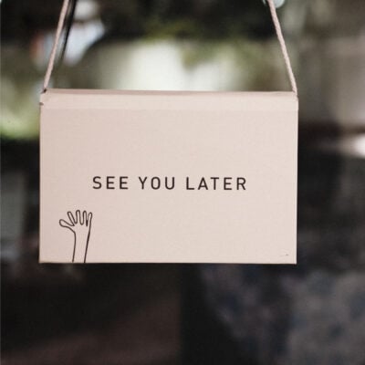 sign on door says "SEE YOU LATER" with a hand waving goodbye