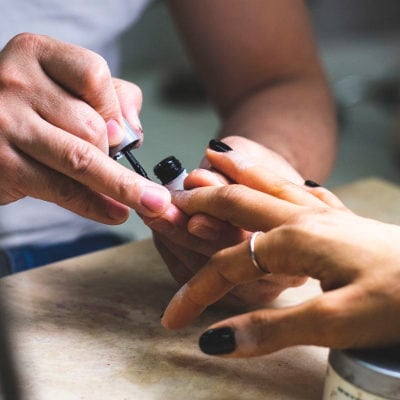 professional woman getting her nails painted