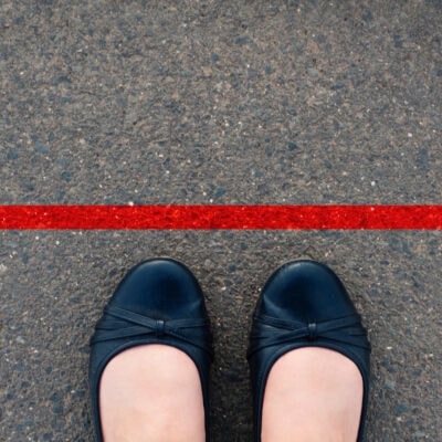 woman's ballet flats are close to a red boundary line