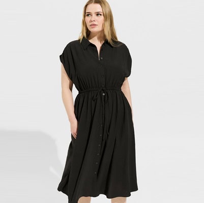 A woman wearing a black shirtdress