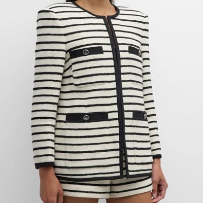 A woman wearing a black and white stripe jacket and shorts