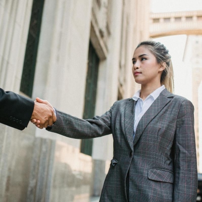 young professional woman wears sloppy ponytail with her suit