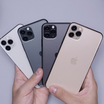 person holds four iphones, fanned out like cards