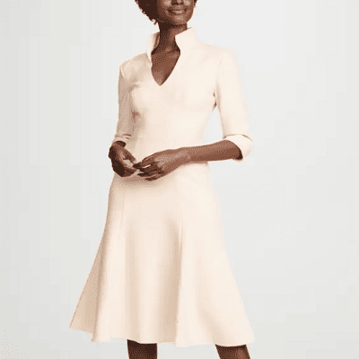 A woman wearing a v-neck white dress