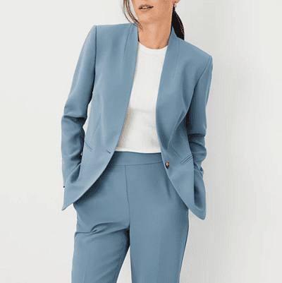 a woman wears a dusty light blue suit