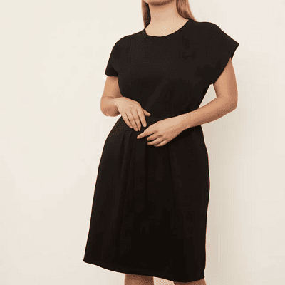 A woman wearing a Vince black tie waist dress